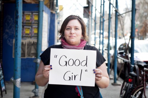 A rape victim displays her poster with lyrics from Thickes Blurred Lines.