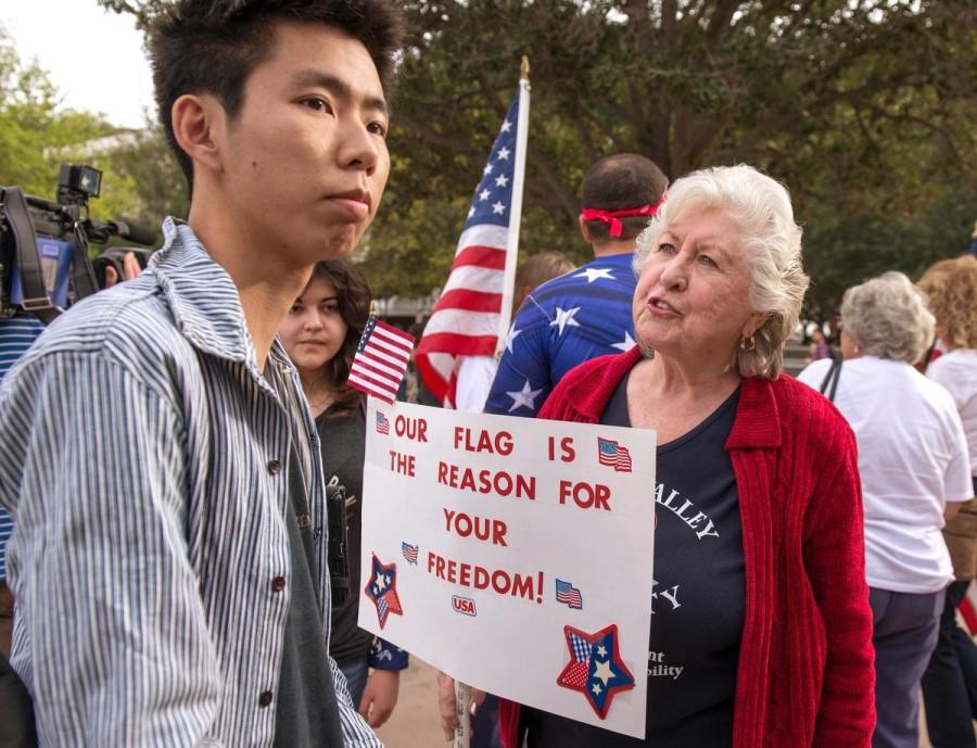UC Irvine student Patrick Lim and pro-flag protester Carol Schlaepfer argue during a rally in Anteater Plaza.