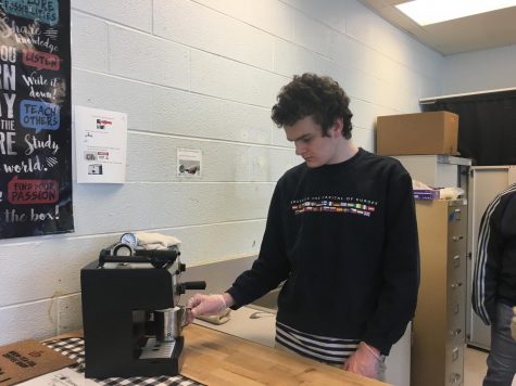 Collin Sproule, a Brew-Tea-Ful Coffee Shop employee, makes coffee for students during 7th period. 