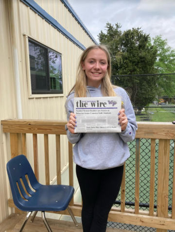 Sophomore, Phoebe Schultz, holding the spring edition of The Wire.