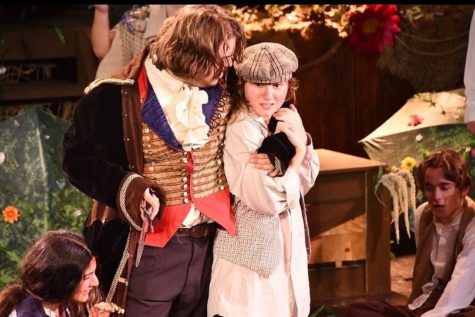 Captain Hook (Antonio Amaral) threatens a lost boy. Photo from Beyond The Page theatre company.