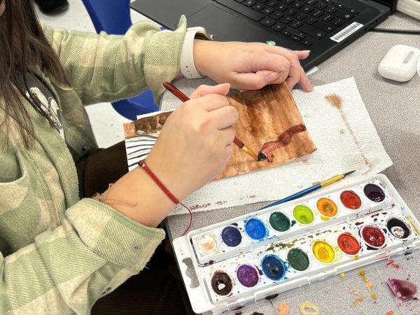 Student Marie Wheeler painting with water colors