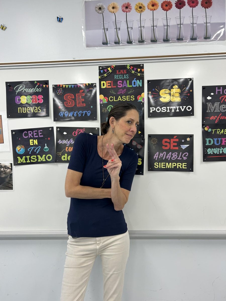 Ms. Veltman posing in her beloved Spanish classroom.