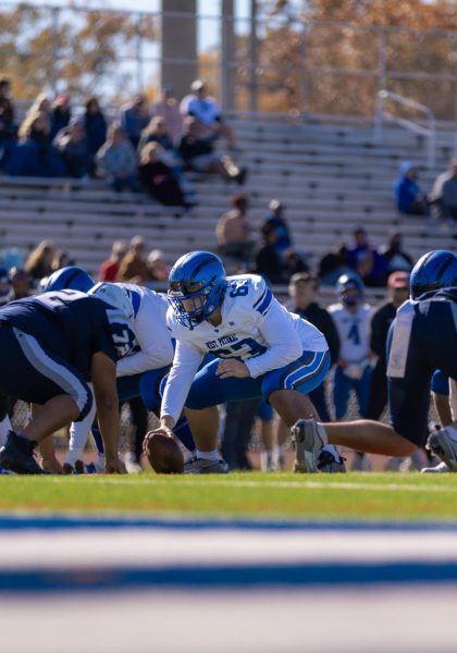 Junior Center Kevin Dumitrescu ready to snap the ball against Woodson HS on in a 44-0 rout on November 2.   Photo Credit: Rhys Hancock, Sophomore