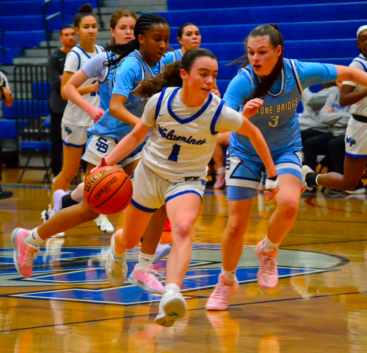 Senior Olivia Jones takes on Stone Bridge defender on the way to the net