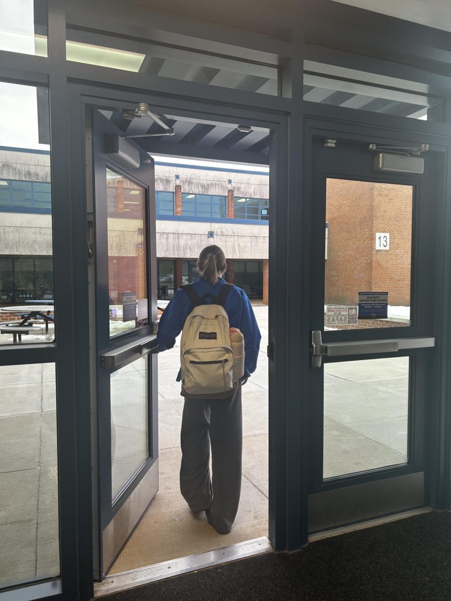 Student leaves early from school out of side door, one of many who may be taking a mental health break from school.