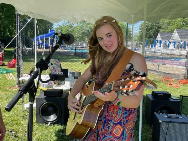 Lydia Grace, junior, plays the guitar at this year’s Waynewoodstock, which also served as a post-storm distraction.   