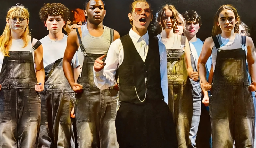 Hades with his workers in line behind him while singing "Why we Build the Wall."