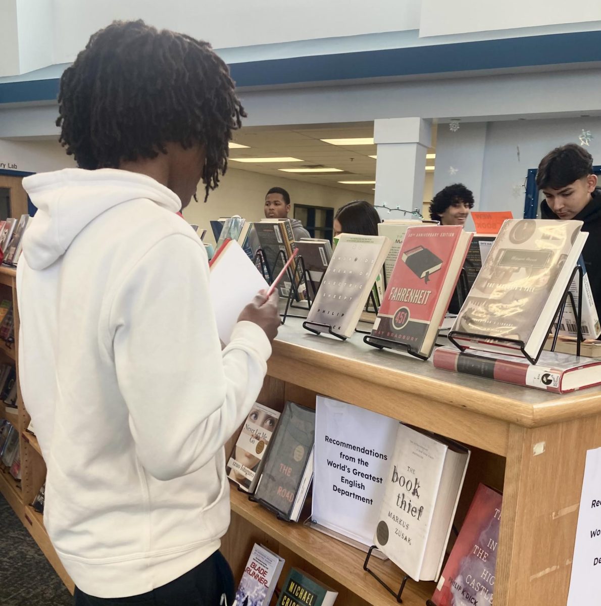 Students peruse the recommended book shelves for a great pick to read over the holidays.