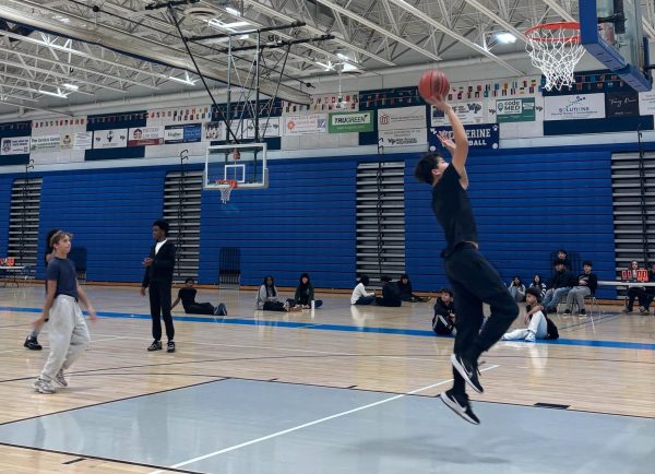 Students attempt to shoot into the baskets as they practice for the championship games.