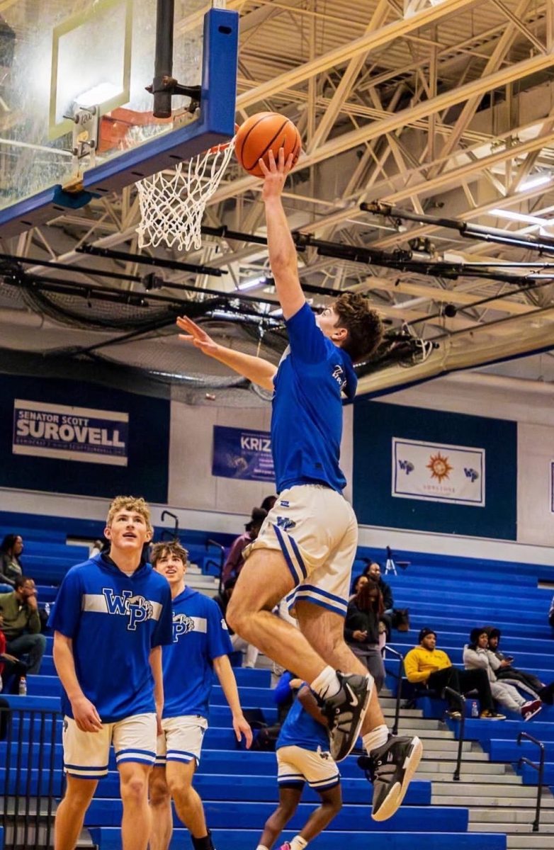 Junior Jack Coulter scores a layup in warmups before a game. 
