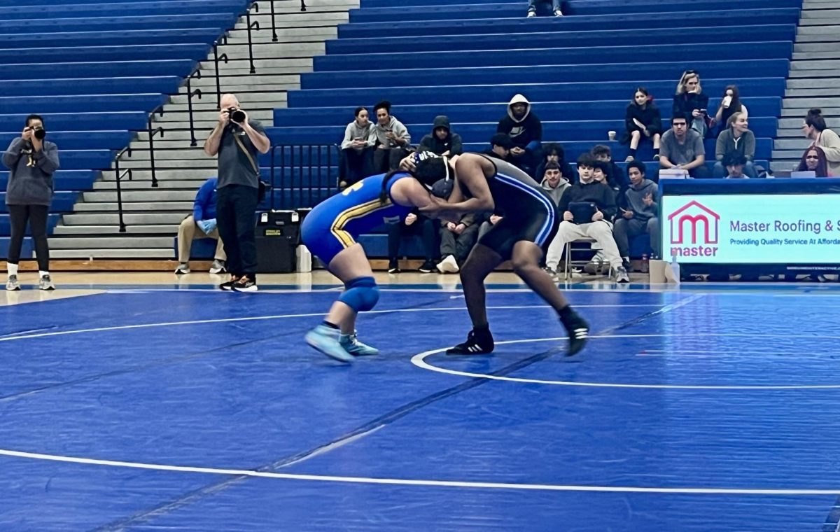 West Po girls wrestler grapples with Robinson wrestler during an in-
school match.