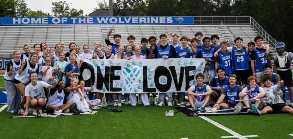 All of the One Love club coming together for a photo.