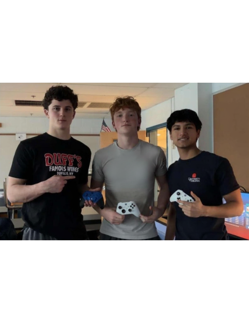 West Po Rocket League team athletes Eamon Kretzer, James O'Neill and Alex Nestares pose for a shot with Xbox controllers.