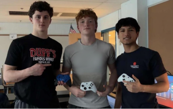West Po Rocket League team athletes Eamon Kretzer, James O'Neill and Alex Nestares pose for a shot with Xbox controllers.